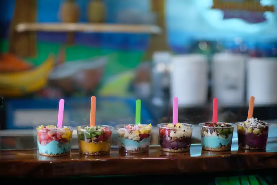 Magic Smoothies açaí bowls lined up on the counter against the shop's hand-painted murals